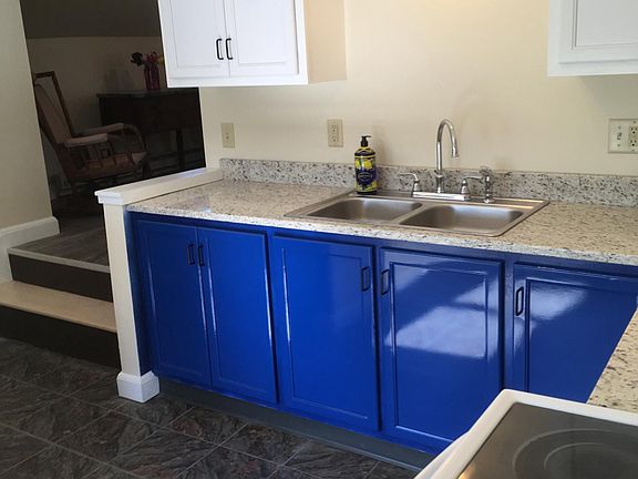 The brand new kitchen has plenty of light and storage and features granite counter tops and an eat-in breakfast bar.