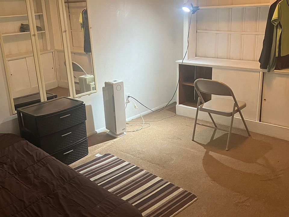 Twin bed along Wall, built-in clothing unit, mirror,nightstand