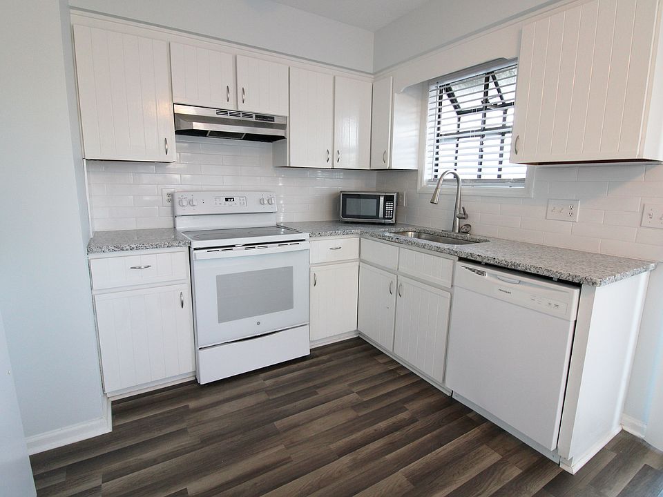 Kitchen with new granite counter tops and a fresh new subway tile backsplash.