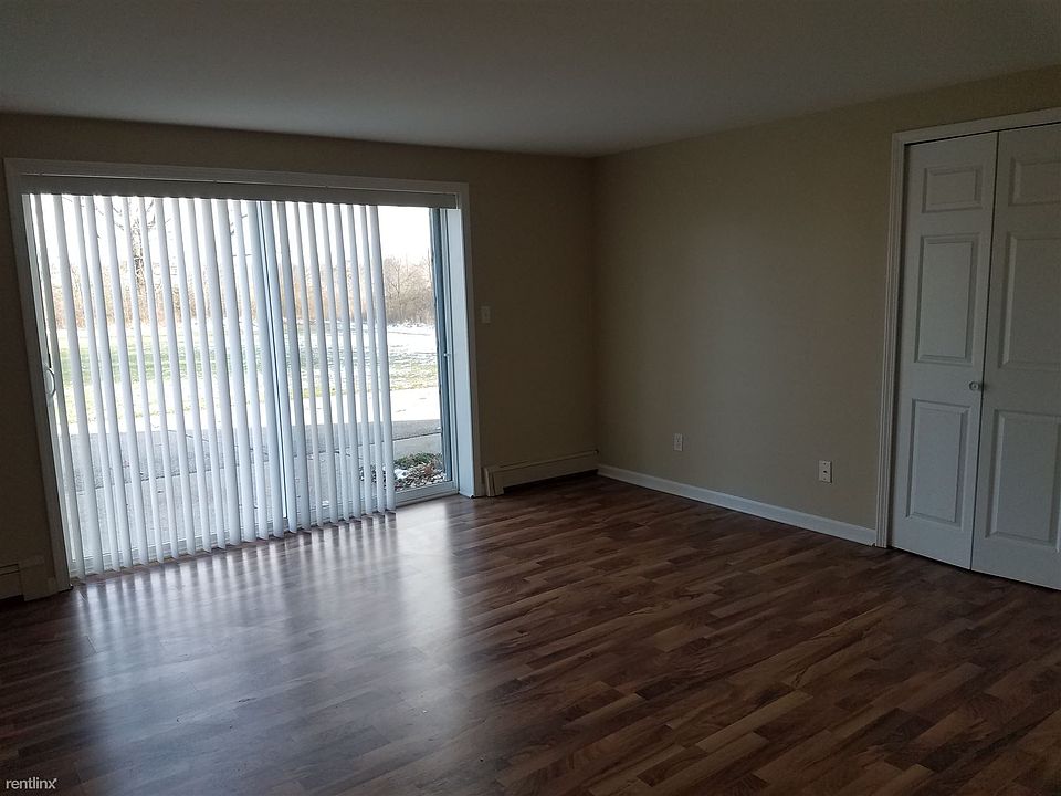 Living room with glass door wall leading to private patio