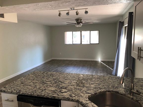 View from the Kitchen of bar seating area and Living Room