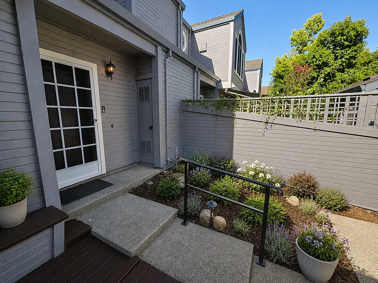 Imagine the possibilities! This private patio offers a blank canvas for creating your own outdoor oasis, with plenty of room for seating, potted plants, or a garden. (This image has been virtually enhanced to illustrate potential landscaping.)