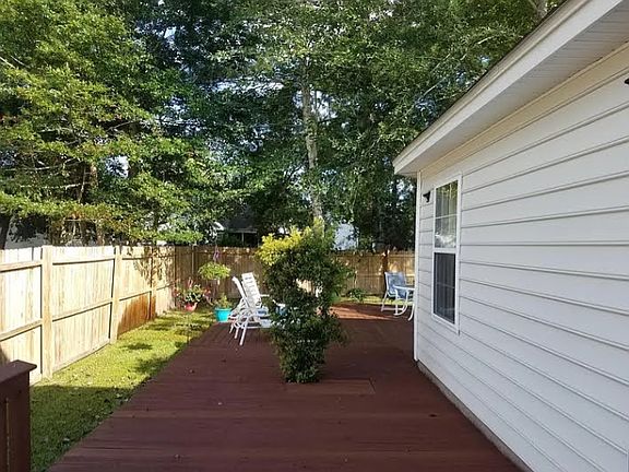 Fenced in backyard with wrap around deck