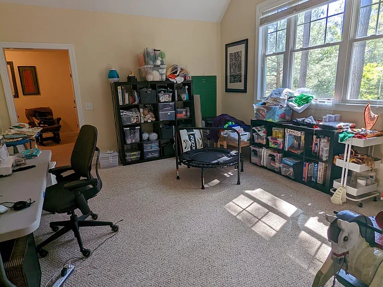 Large bonus room upstairs with huge windows filling the space with natural light.