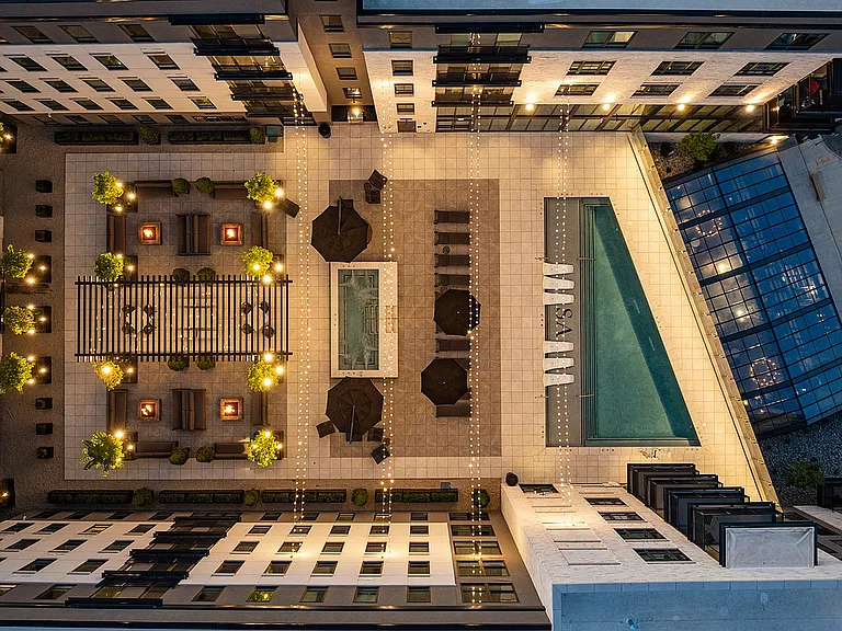 Overhead view of rooftop pool deck with glowing lights