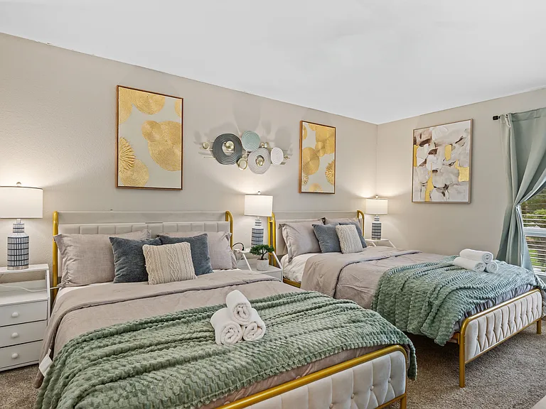 Enjoy restful nights in the well-lit space with two cozy queen beds.