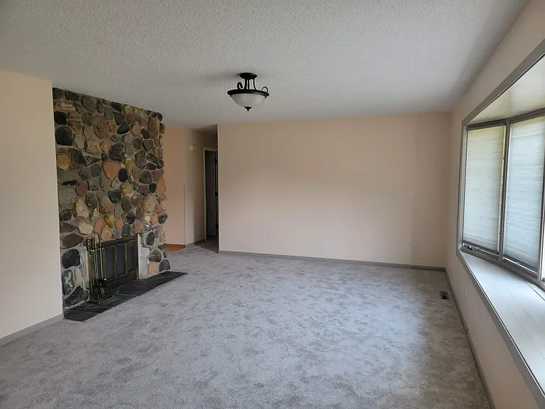 Living room. Granite stone fireplace for ambiance only (no fires allowed). New paint, carpet, cellular shades,