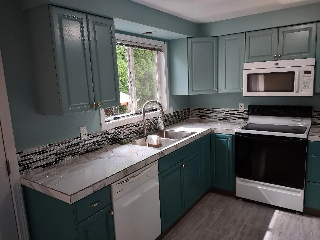 Kitchen sink area with bright light from window. - 190 SE 3rd Ave