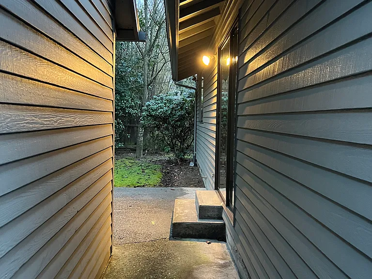 Walkway between duplex and Large storage shed. Small patio, and backyard. Landlord in charge of lawn maintenance.