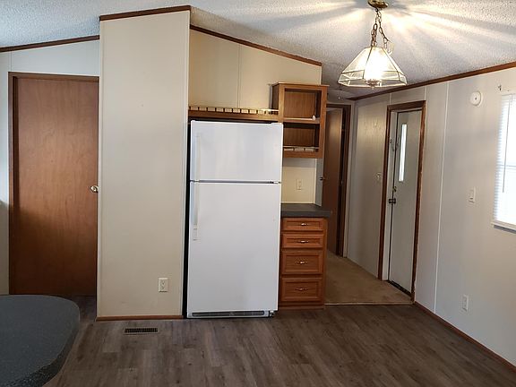Kitchen showing refrigerator and back door