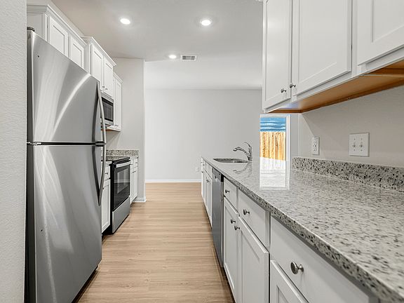 Enjoy stunning granite countertops and designer wood cabinetry in this kitchen.