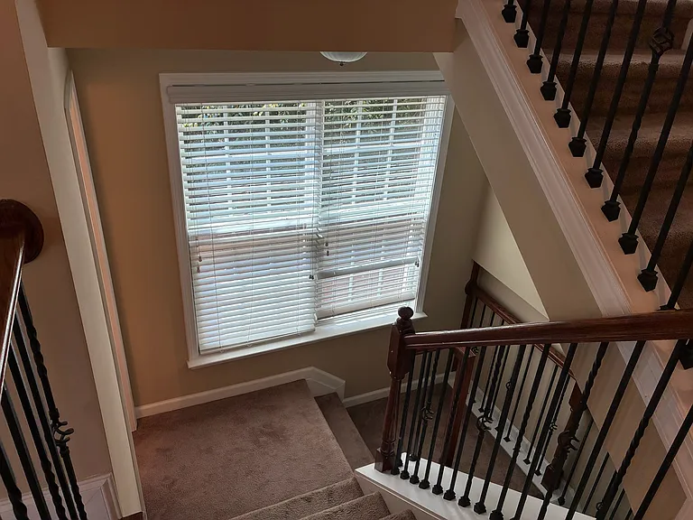 Stairs going down to the 4th bedroom