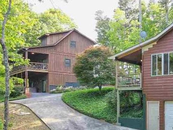 View of large house and cabin on property