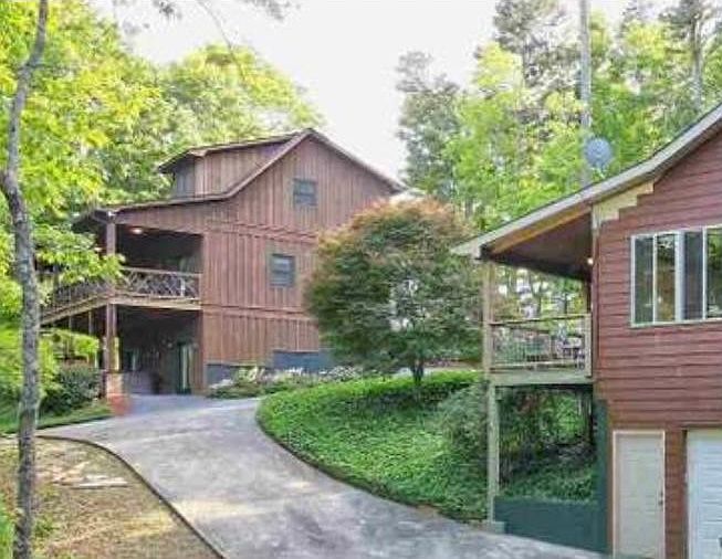 View of large house and cabin on property
