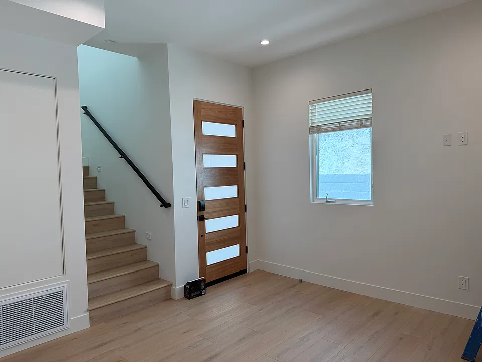 Front door and stairs leading up to desk and master bedroom suite