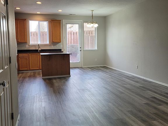 Spacious living area leading into dining and kitchen areas