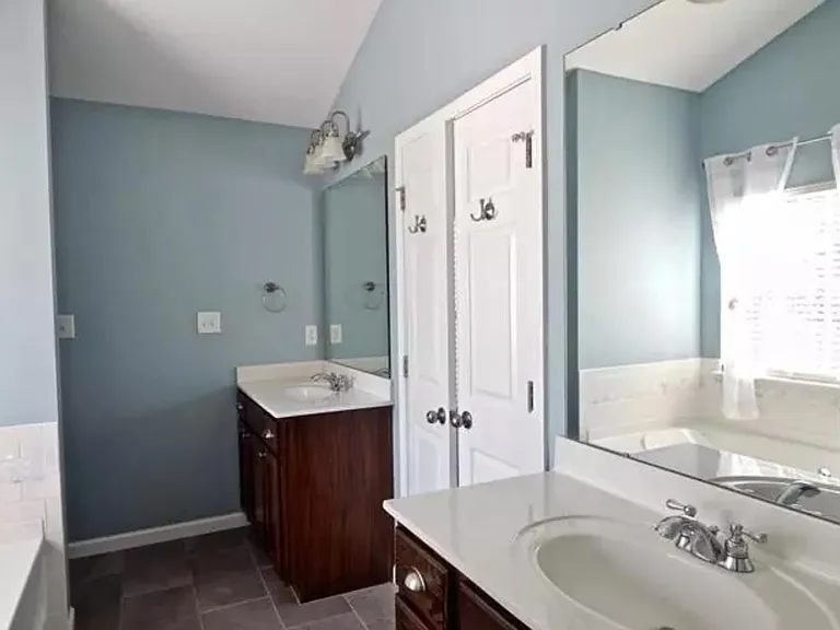 Master bath with dual vanities, separate Tub and glass shower