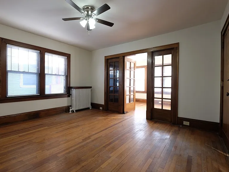 Welcome to Central Lakes of Uptown, where spacious living meets charm. This inviting room features natural light, classic wood accents, and a cozy ceiling fan. Make this your new home today! Schedule a tour and see the possibilities for yourself.