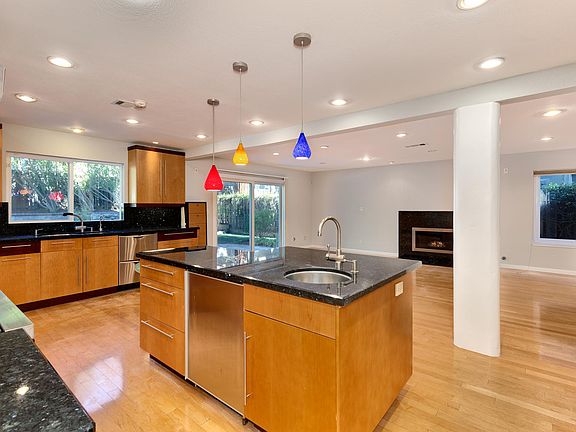 Spacious kitchen opens to the family room with a fireplace for added warmth providing easy access to the backyard entertaining areas.