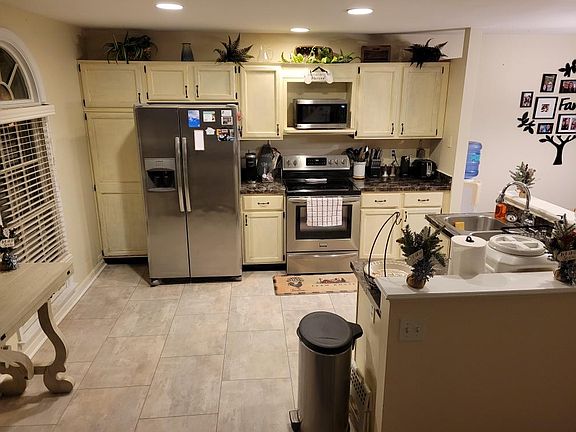 Kitchen from bottom of second level stairs perspective.
