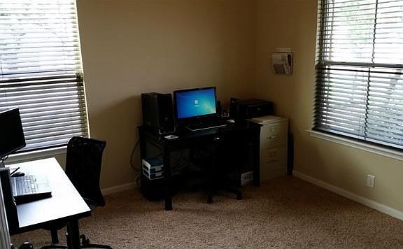 Spacious front office with french doors and upgraded carpet.