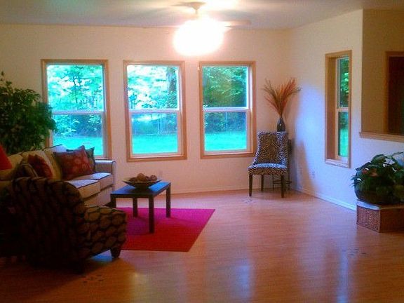 Large open living room with no glue wood laminate floors.