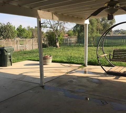 Side View of back patio showing RV parking space towards further left side.