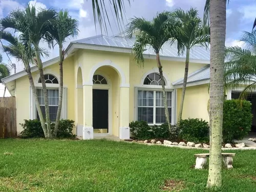 JUPITER HEIGHTS Beautiful yellow concrete built home with new metal hurricane roof and accordian shutters. - 6332 Ungerer St