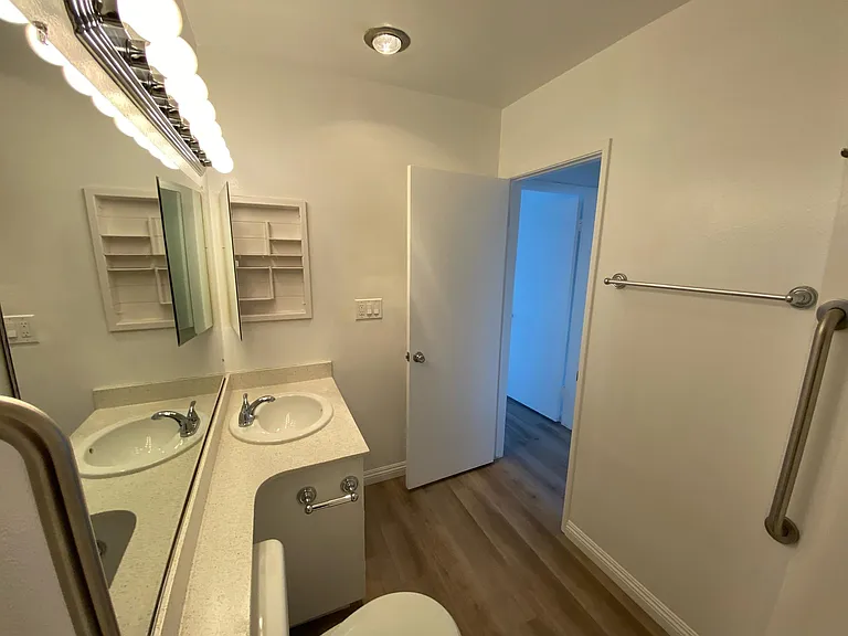 Standing at the tub/shower in a primary bathroom 1x1 Medicine cabinet is open.