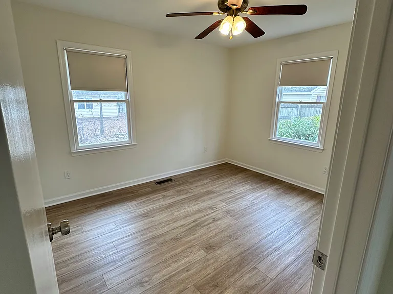 Final photo of Bedroom #3 with a view of the side yard and backyard.