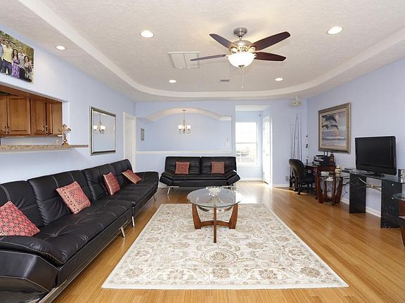 Large living area features bamboo wood flooring, recessed lighting and water views.