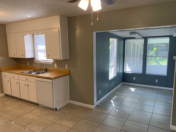 kitchen and showing into the Florida room leading to the screen porch