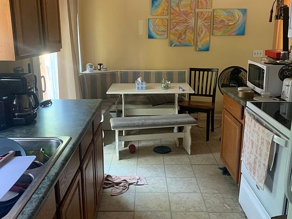 Galley kitchen. Slider to left of table leads to porch/deck. Living room is to the right.