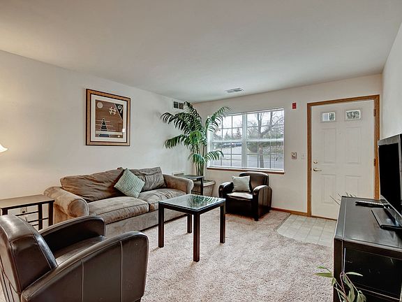 Arbor Ridge Living Room View with Couches, Television, and Window