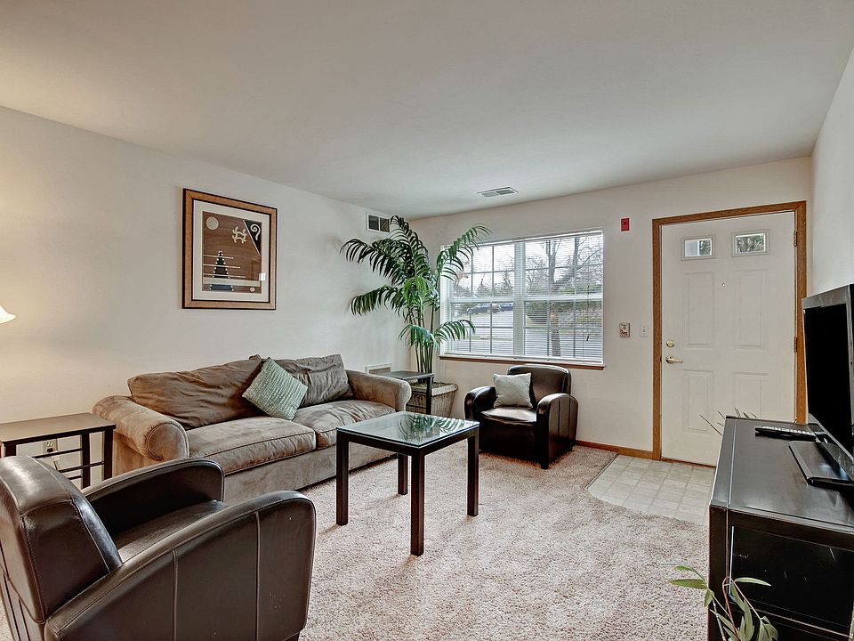 Arbor Ridge Living Room View with Couches, Television, and Window