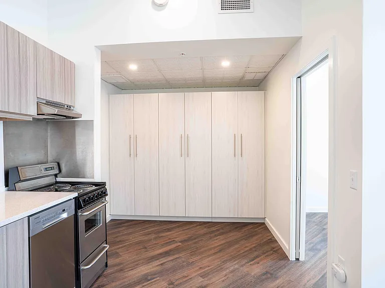 Kitchen with Energy Star appliances and quartz countertops; BR through the door to the right