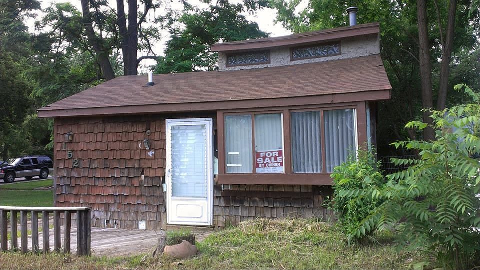 Front of house, to the left there is a small porch