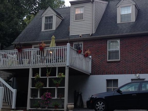 Back of home with large deck