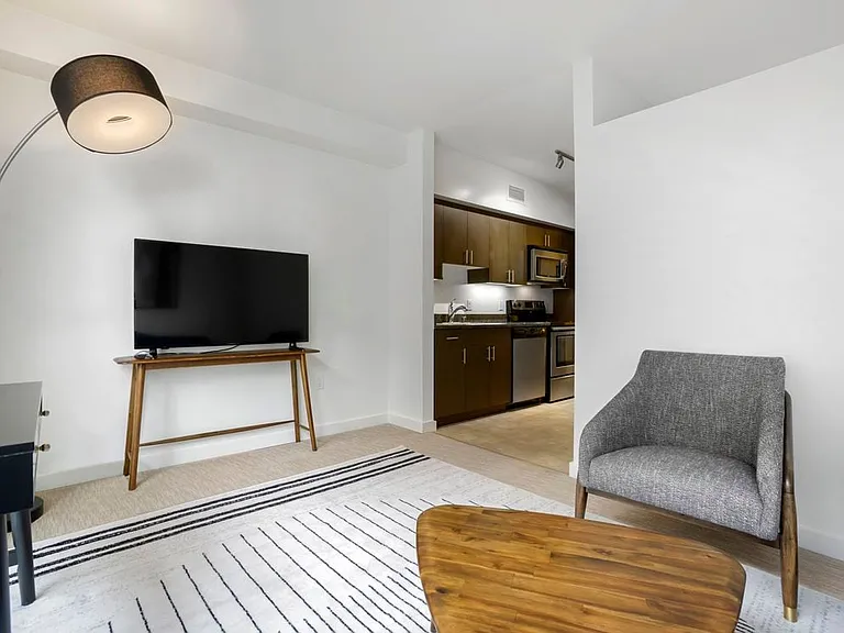 Furnished+ apartment homes come outfitted with a sofa, side chair, side table, coffee table, TV stand and 50" Television (Representative Image exact items and style of furnishings may vary)