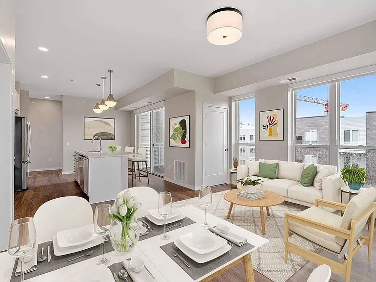 Open concept living room, dining area, and kitchen at The Hallon Luxury Apartments in Hopkins MN