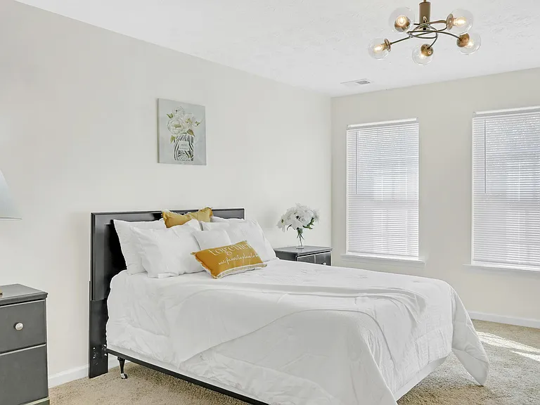 Oversized room with queen bed and closet.