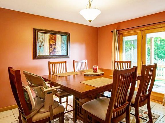 The dining room is steps from the kitchen, has ceramic tile floors and allows for excellent views of the back yard with the Anderson french doors which lead to the covered porch.