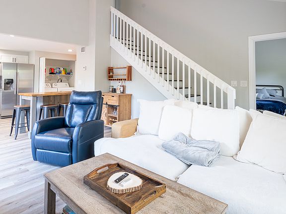 Living room, entrance to guest bedroom, kitchen, + laundry