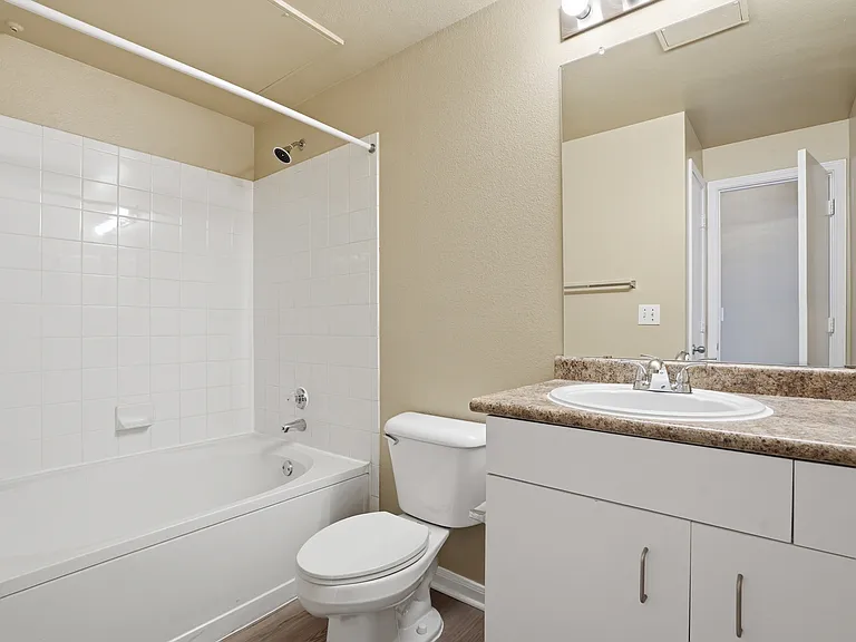Classic bathroom with shower tub combo and sink with underneath storage