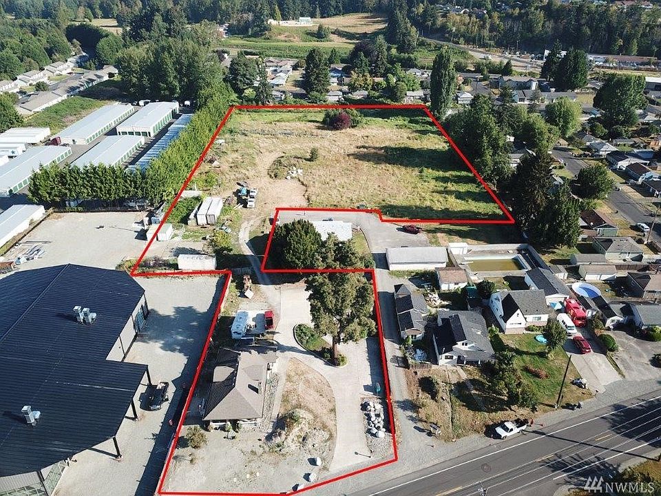 Puyallup address Pierce County 4 adjacent parcels 4.53 AC two homes front parcel sewer water on property zoned MUD Entrance off Valley Ave E Puyallup WA 98372