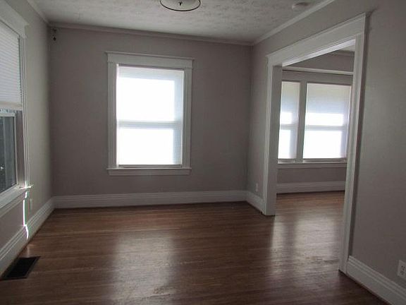 Living room / dining room - note all windows with soft shades