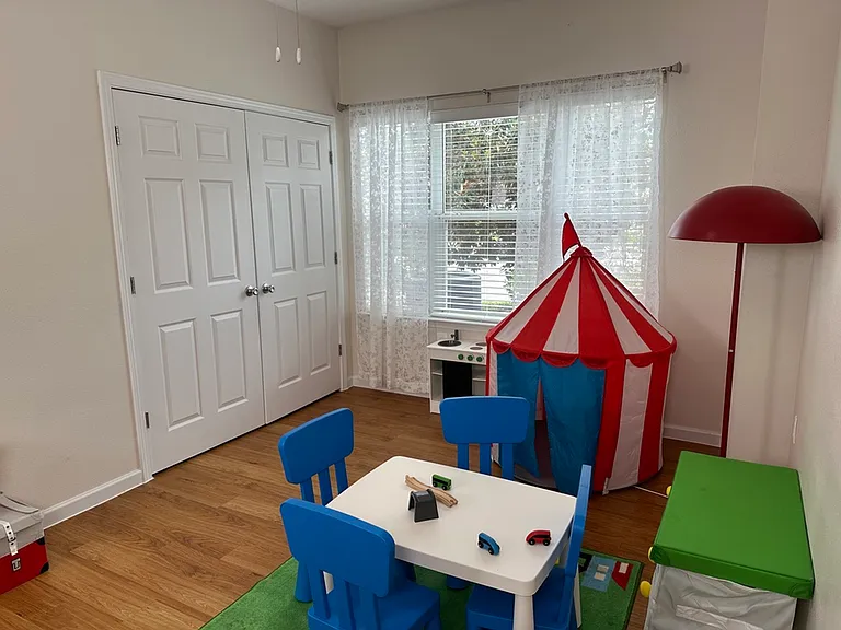 Bright and cheerful kids' playroom with a circus tent, colorful chairs, and engaging toys, perfect for imaginative adventures. Bright and cheerful kids' playroom with a circus tent, colorful chairs, and engaging toys, perfect for imaginative adventures.