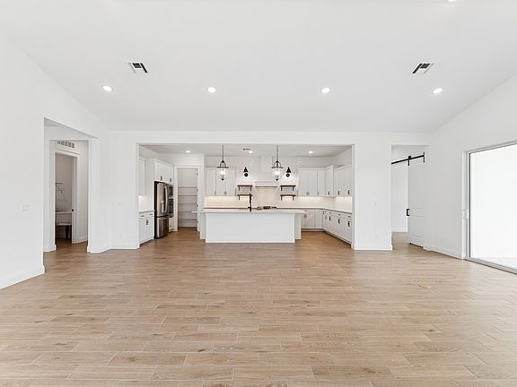 Open concept living spaces with vaulted ceiling