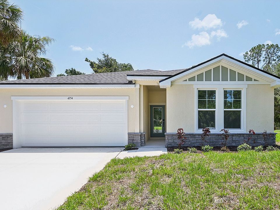 Elegant gabled roof and stone accents enhance this North Port home s curb appeal and architectural s