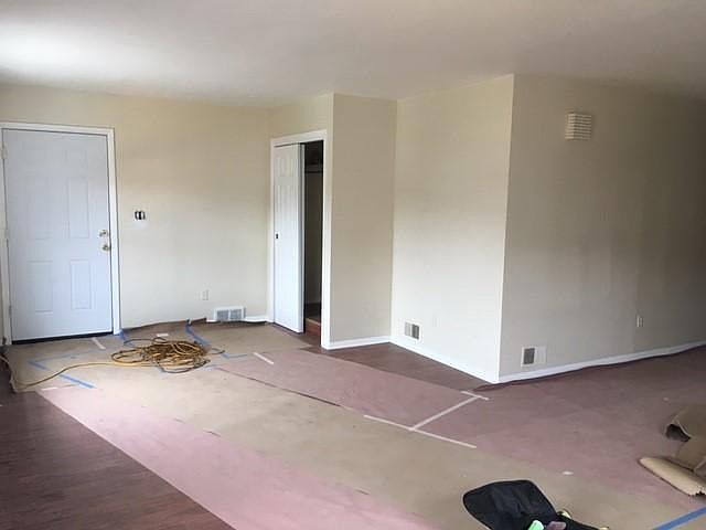 View of the front door and closet, some of the living room. 